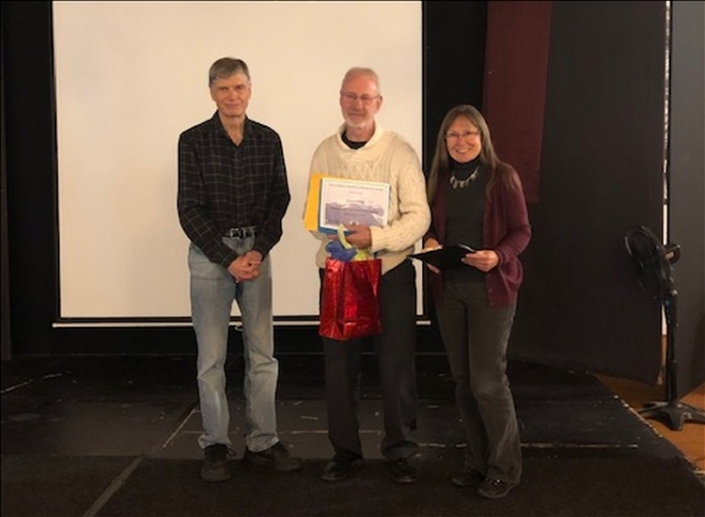 Picture of Nowell (middle) receiving award