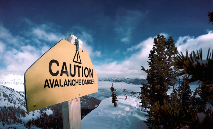 View of avalanche warning sign on top of mountain.